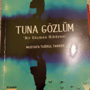 TUNA GÖZLÜM "Bir Göçmen Hikayesi"/Mustafa Tuğrul TANSER